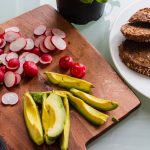 banana fruit and bread on brown wooden chopping board